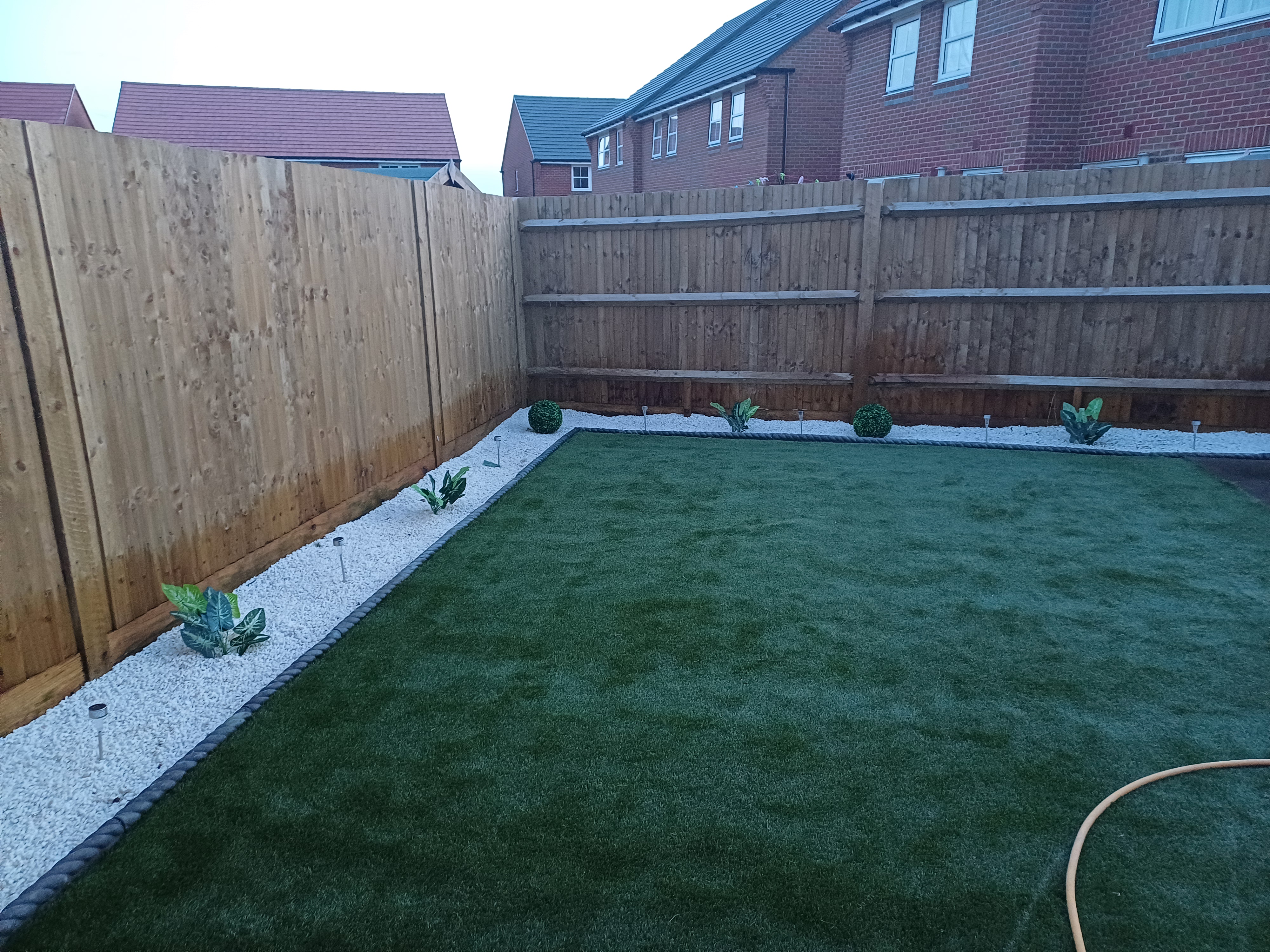 Newly installed artificial grass with white gravel borders and edging in Oxfordshire — by JP Garden Maintenance